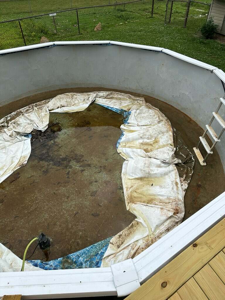 Pool with torn, failing vinyl liner before replacement