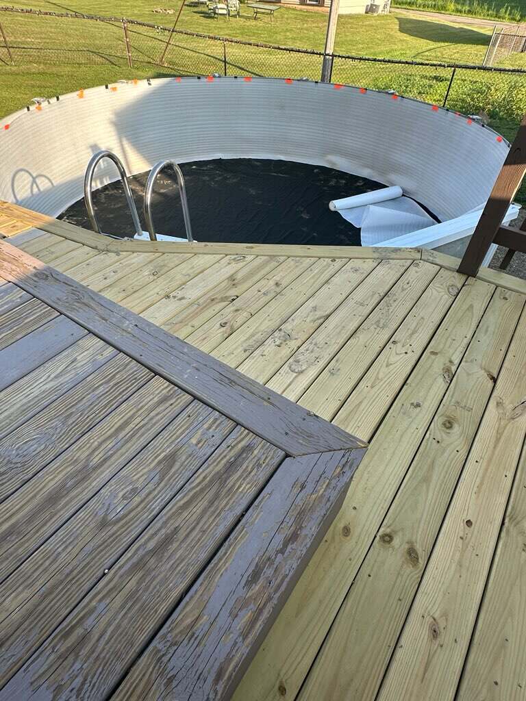 New pressure-treated deck boards installed and finished