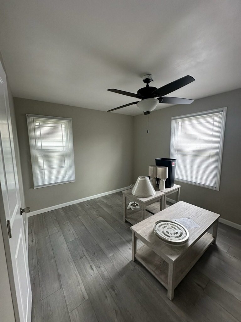 Finished room with new wood-look plank flooring and ceiling fan