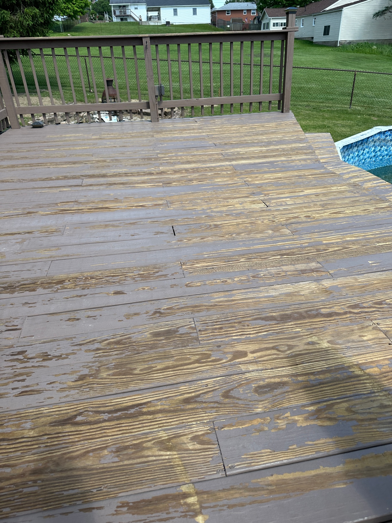 Deck refinishing prep — old finish stripped back, boards exposed across full deck